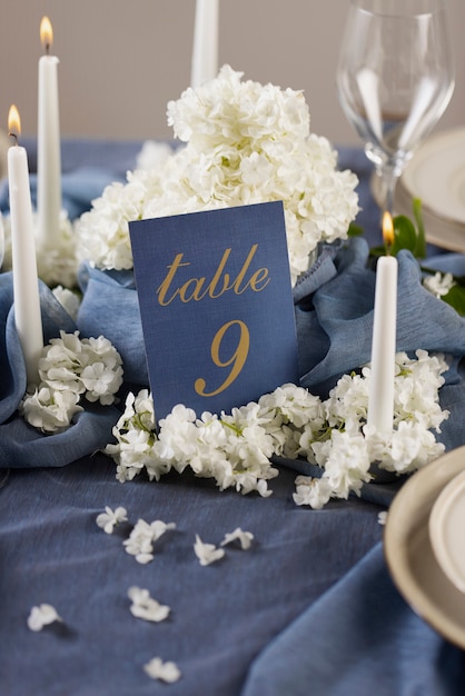 Free photo high angle wedding table number with flowers