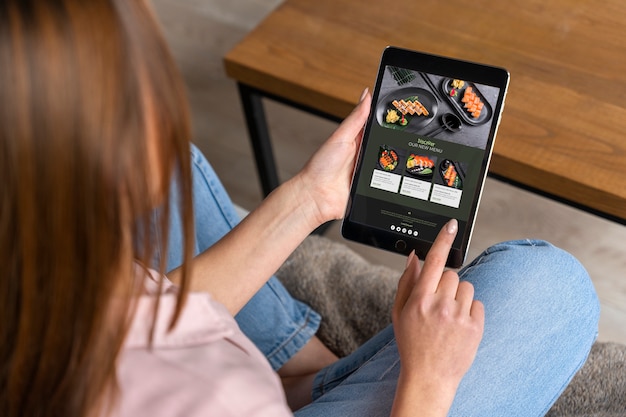 Free photo high angle woman ordering sushi