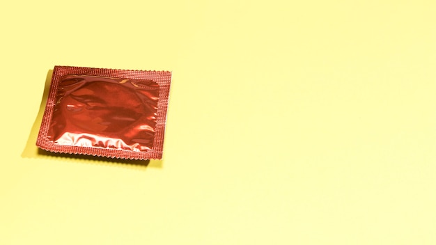 Free photo high angle wrapped condom with copy-space