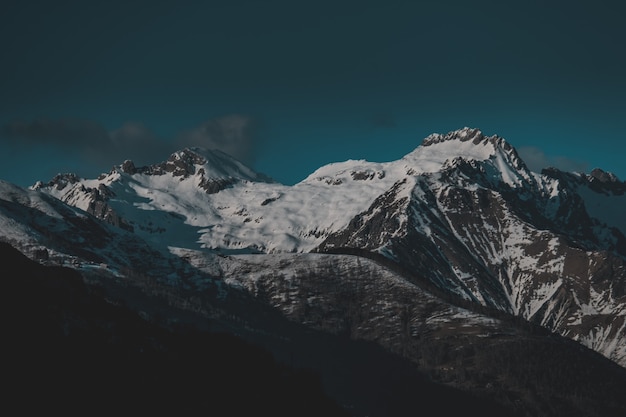 Free photo high mountains covered with snow in the evening