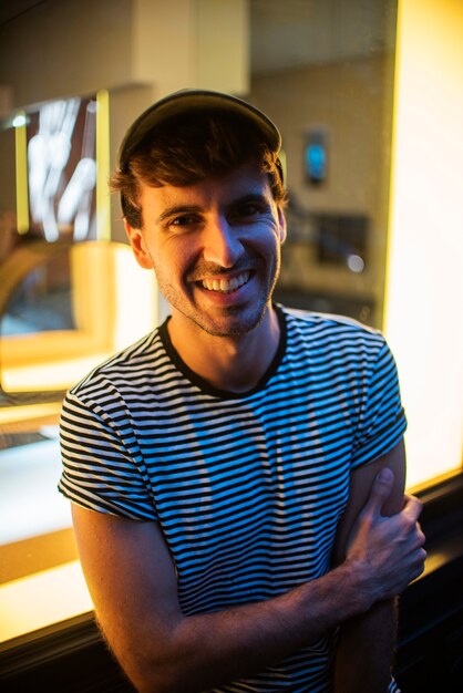 High view shot of smiley man wearing a cap