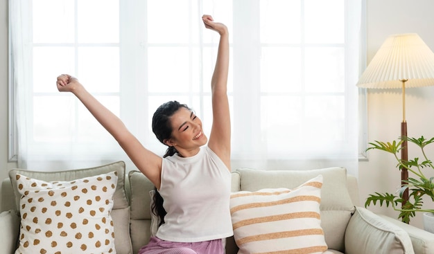 Free photo home lifestyle asian woman relaxing on sofa in living room