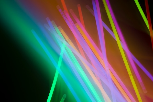 Free photo illuminated glowing neon tubes on colored background