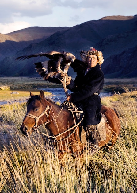 Kazakh men traditionally hunt foxes and wolves using trained golden eagles. Olgei,Western Mongolia.