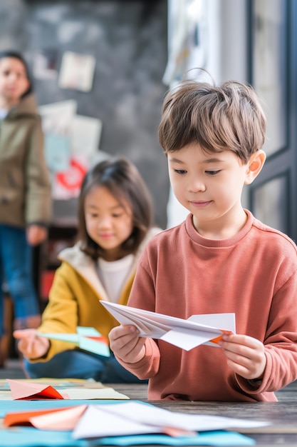 Free Photo kid playing with paper plane