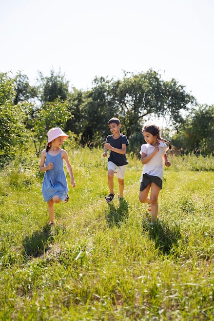 Free Photo kids running and playing in grass field outdoors