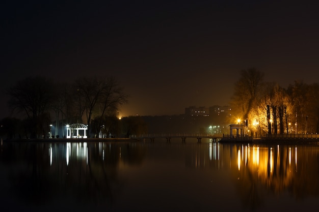 Lake at night with a house and lights