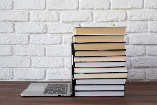 Laptop and books on table