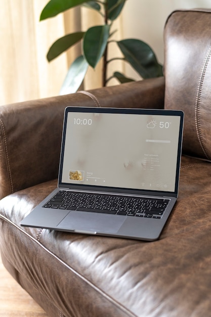 Free Photo laptop on a leather couch