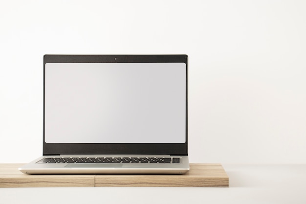 Free Photo laptop minimal display on wooden board