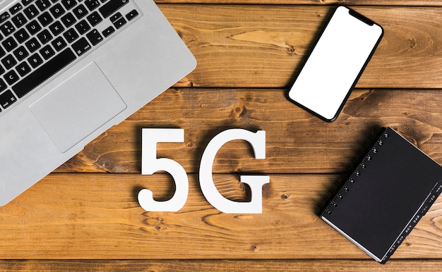 Free photo layout of 5g and gadgets on desk