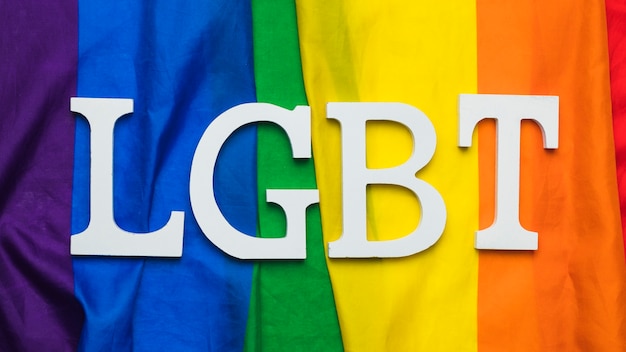 Free photo lgbt lettering on rainbow flag