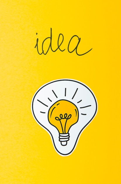 Free photo light bulb idea concept on yellow background