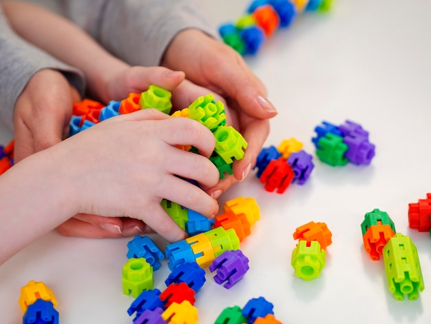 Free Photo little boy playing with colorful game