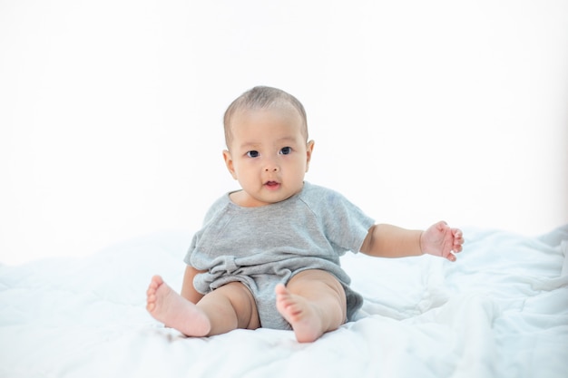 Free Photo the little boy sitting on the bed