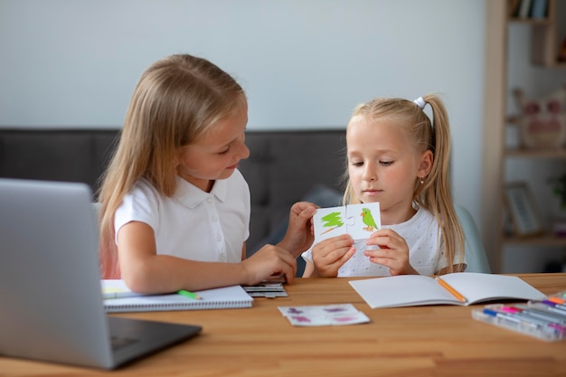 Free Photo little girls doing online school together