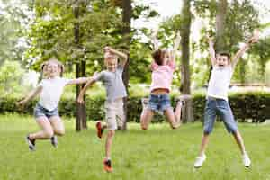 Free photo long shot kids jumping together