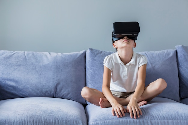 Free photo lovely little girl having fun with virtual reality glasses