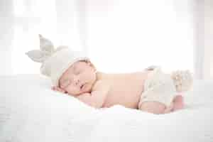 Free photo lovely newborn asian baby sleeping on furry cloth