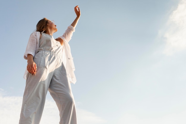 Low angle of woman posing in the sun with clear sky