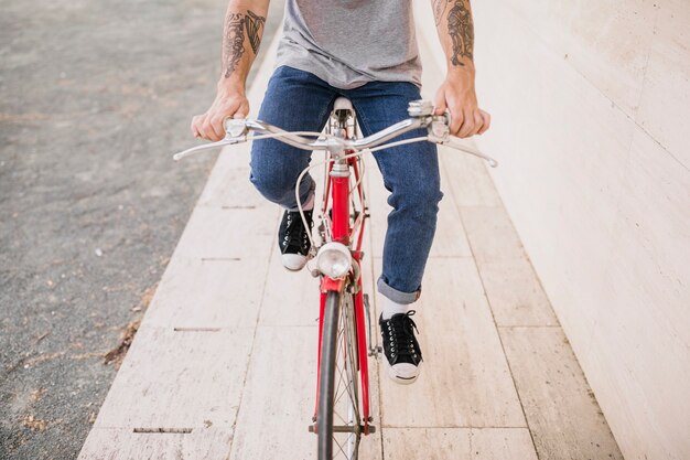 Low section of a person riding bicycle