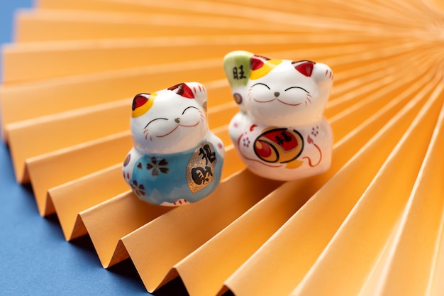 Free photo lucky cats with yellow paper high angle