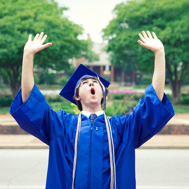 Male in a blue mantle enjoying the freedom after graduation