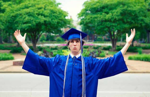 Male in a blue mantle enjoying the freedom after graduation