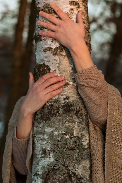 Free photo male model hugging a tree