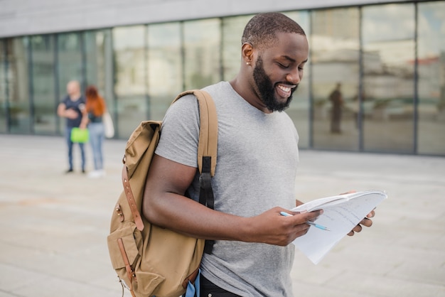 Free Photo male student holding papers