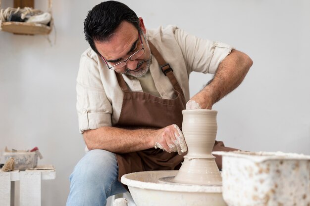 Man doing pottery medium shot