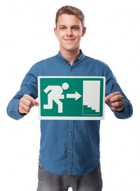 Free Photo man holding an emergency exit sign