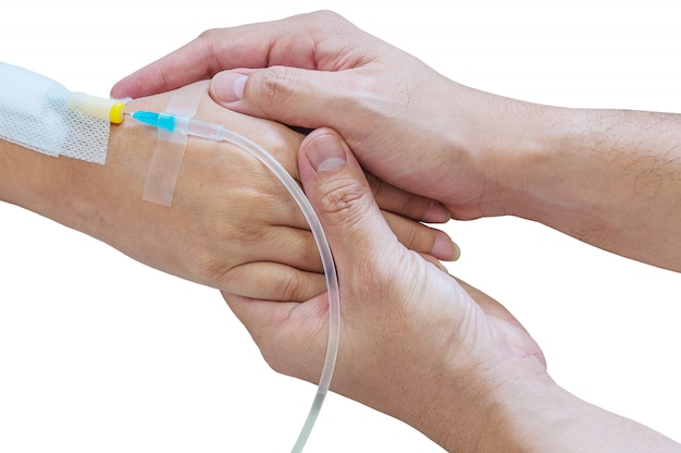 Free photo man holding woman, patient, hand with a tube of medicine injection on a bed in a hospital