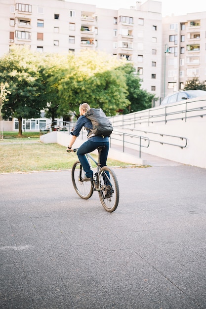 Free photo man riding bike