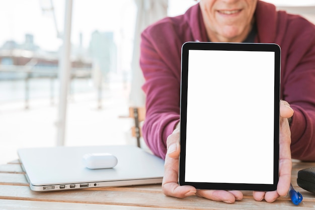 Free photo man showing new digital tablet with blank white screen