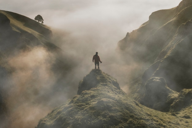 Free Photo man standing on cliff with fog overlay texture