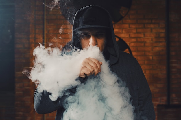 Free Photo man vaping an electronic cigarette