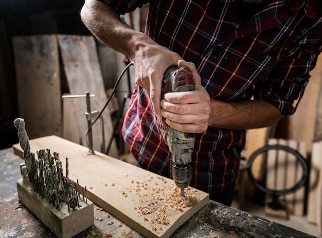 Free Photo man with drill working with wood