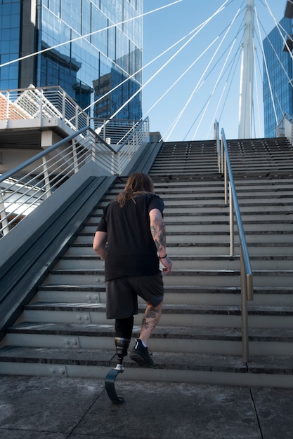 Man with leg disability running in the city