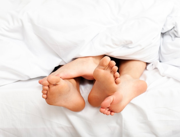 Man and woman having a relaxing morning in bed