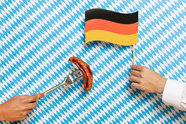 Free Photo man and woman holding sausage and flag