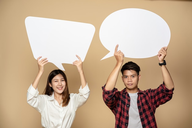 Free Photo man and woman wearing shirts and hold a thought box symbol