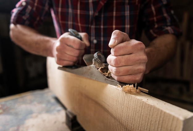 Free Photo man working with wood in workshop