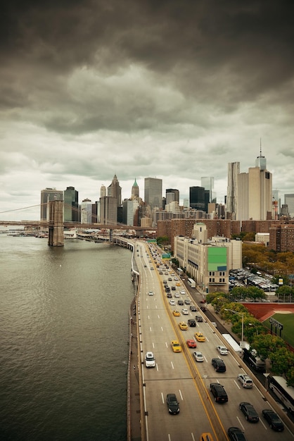 Manhattan financial district with skyscrapers and highway over East River.