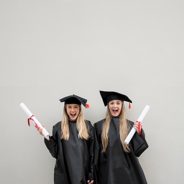 Free photo medium shot happy girls graduating