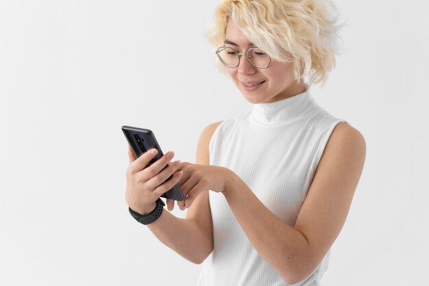 Medium shot woman holding phone