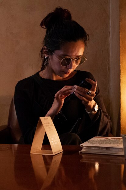 Medium shot woman sitting at table