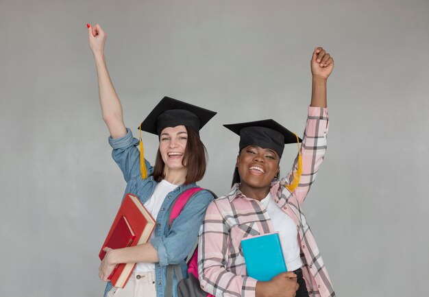 Medium shot woment wearing graduation caps