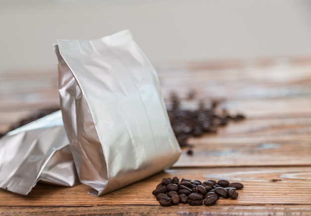 Metallic coffee bag with coffee beans behind