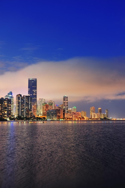 Free photo miami city skyline panorama at dusk with urban skyscrapers over sea with reflection